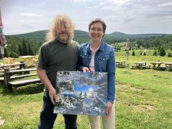 Nationalparkleiterin Ursula Schuster und Pavel Hubený, der Direktor des Nationalparks Šumava, zeigen den "Grenzenlos Wild Kalender 2026". (Foto: Annette Nigl / Nationalpark Bayerischer Wald)