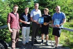 Im Bergfichtenwald am Lusen zeichnete Nationalparkleiter Dr. Franz Leibl (Mitte) den 1.000 Schüler der Mittelschule Zwiesel Dominik Plödt (4 von links) im Beisein von (von links) Thomas Michler, Schulleiter Direktor Josef Wellisch und dem Umweltbeauftragten der Schule Bernhard Perl (rechts) aus